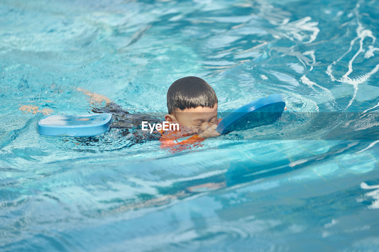 Boy swimming in pool