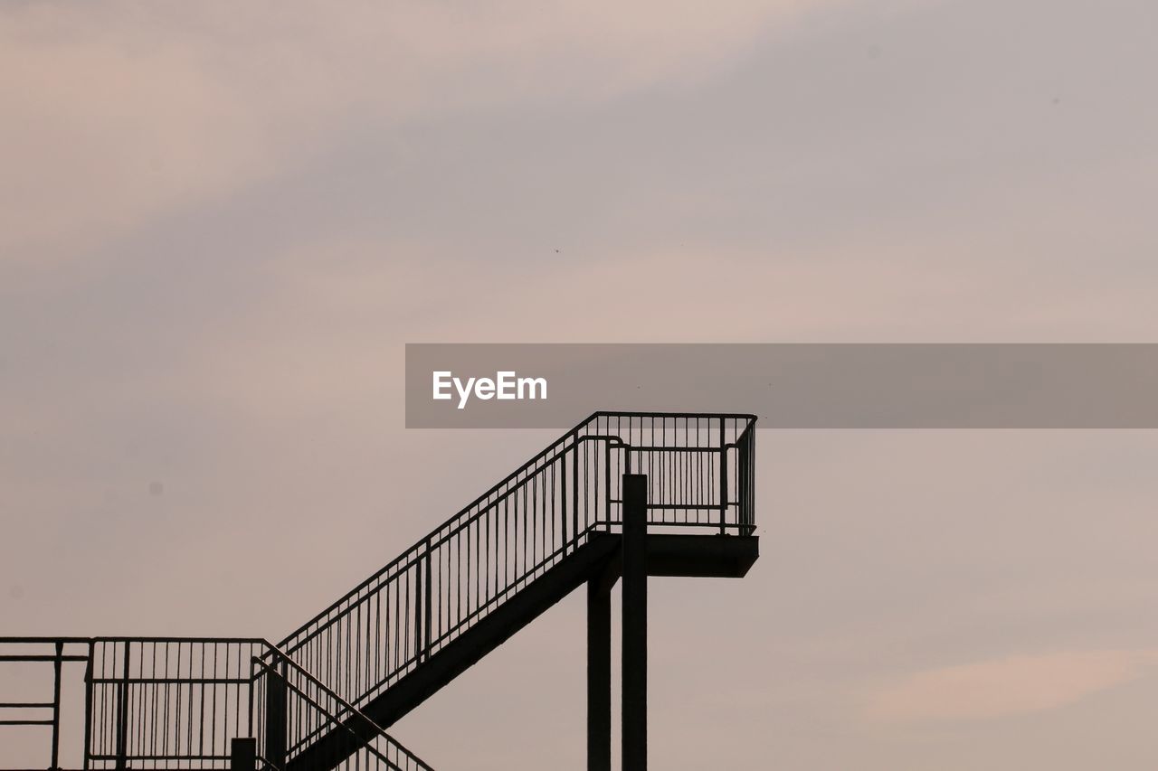 Low angle view of silhouette staircase against sky during sunset