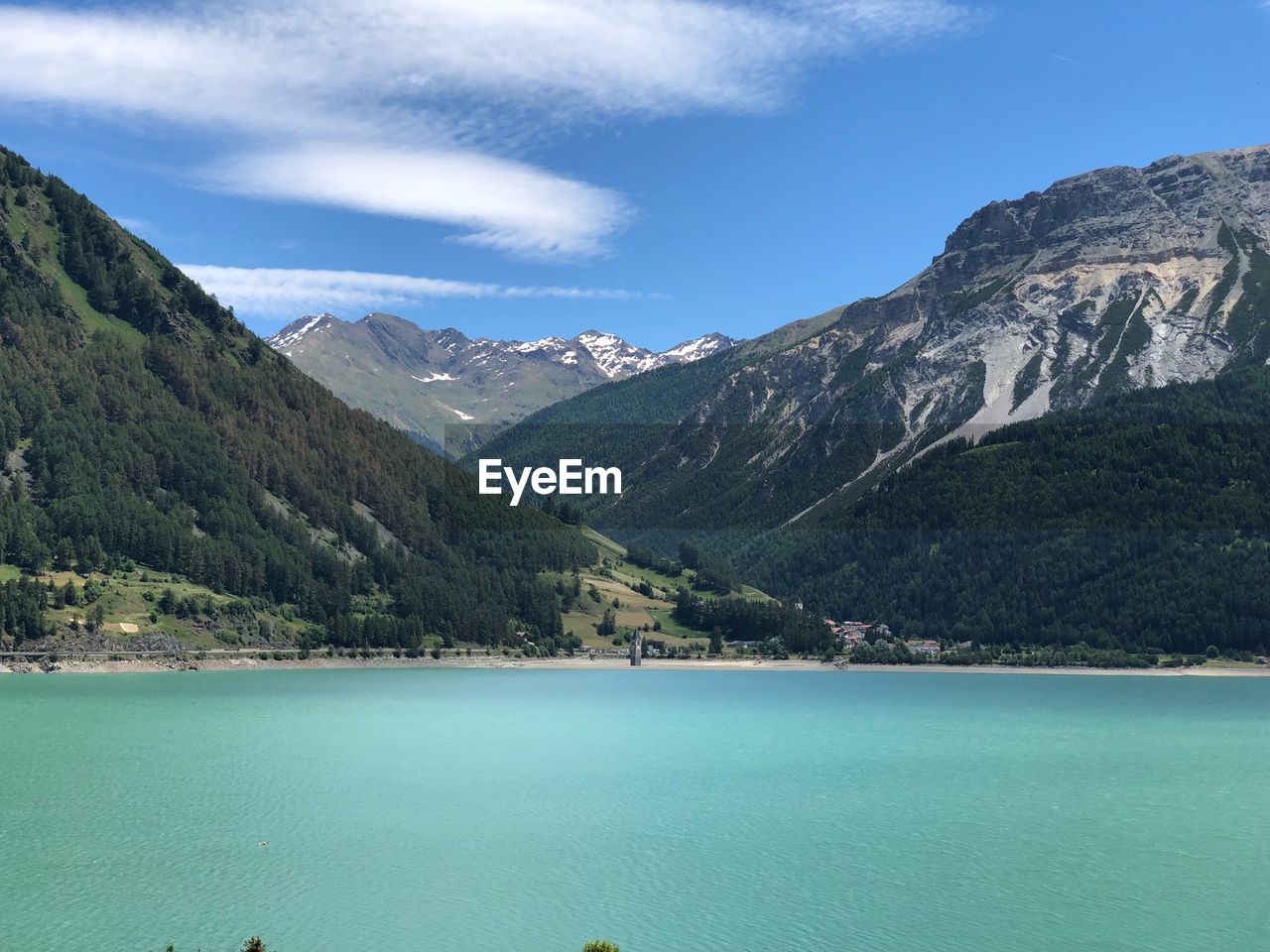 Scenic view of lake and mountains against sky