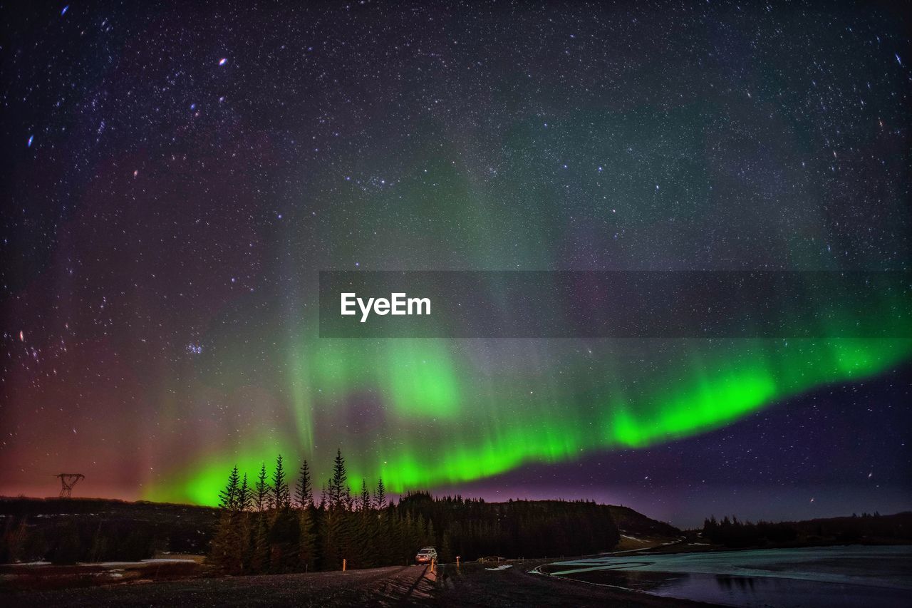 Scenic view of northern lights and star field at night