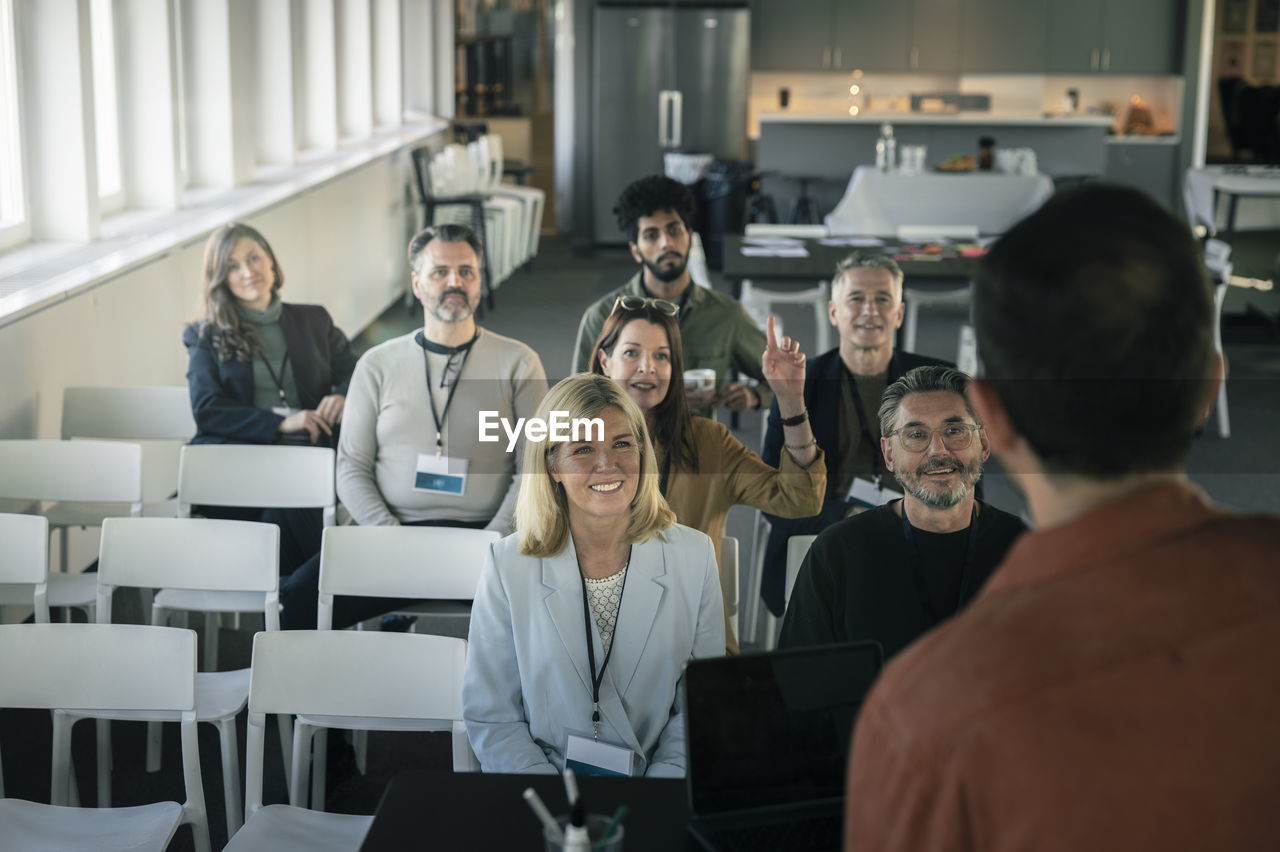 Group of business people attending presentation during conference