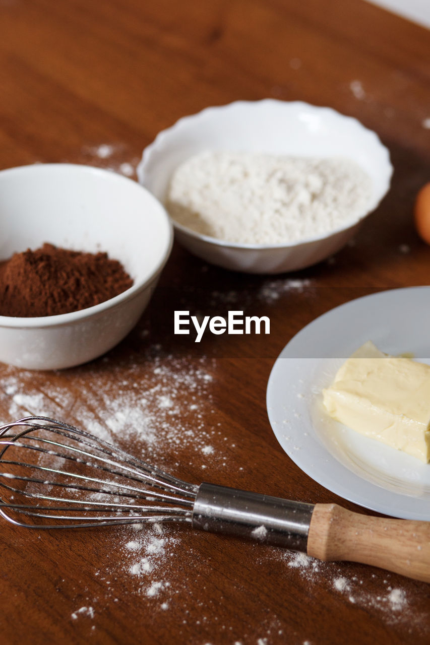 The ingredients needed for preparing homemade chocolate cupcakes