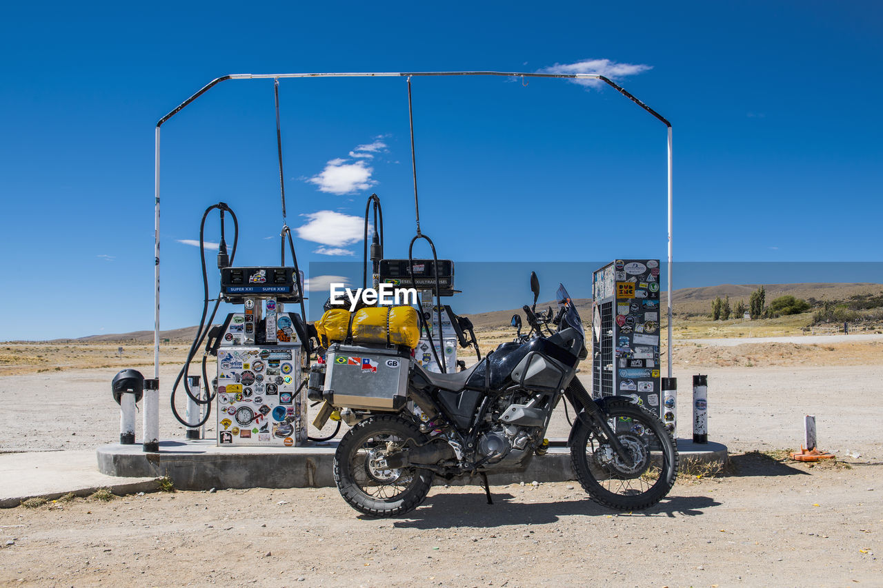 Adventure motorcycle parked at petrol station in remote area