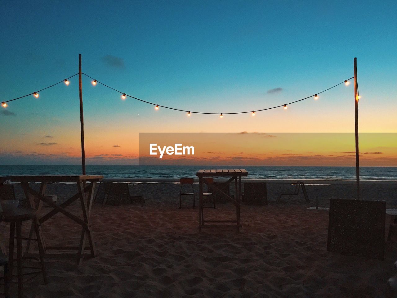 Decoration on beach against sky during sunset