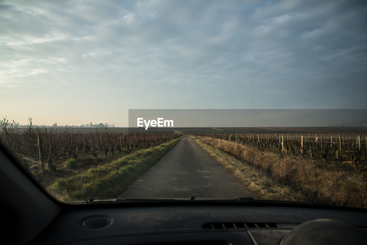 Road passing through landscape against sky