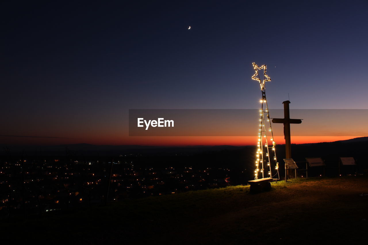 SILHOUETTE TOWER BY BUILDING AGAINST SKY AT NIGHT