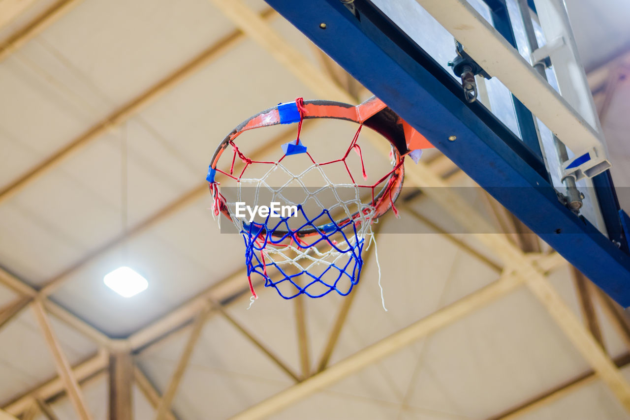 LOW ANGLE VIEW OF BASKETBALL HOOP IN CEILING