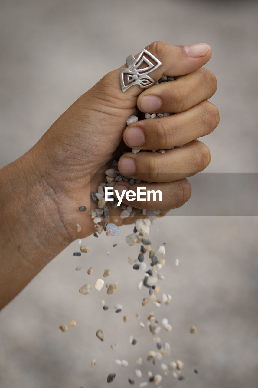 Close-up of woman hands holding sand