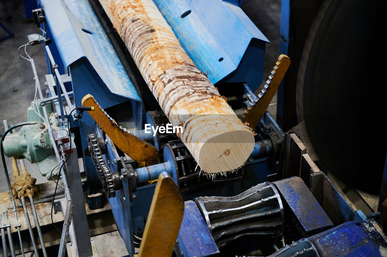 HIGH ANGLE VIEW OF MACHINE PART IN FACTORY