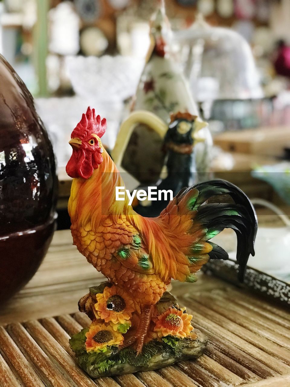 CLOSE-UP OF ROOSTER WITH BIRD ON FLOOR