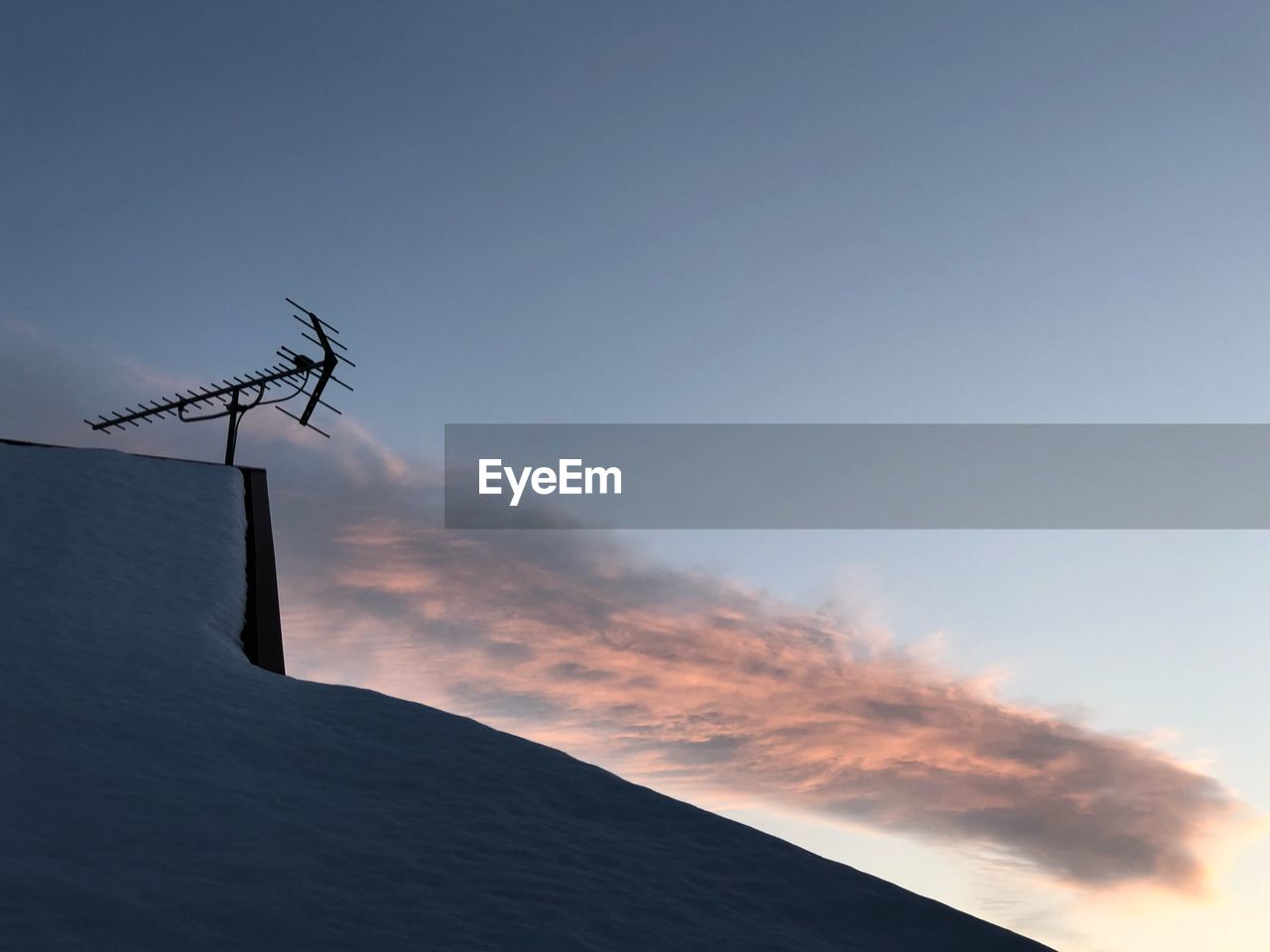 Low angle view of antenna against sky during sunset 