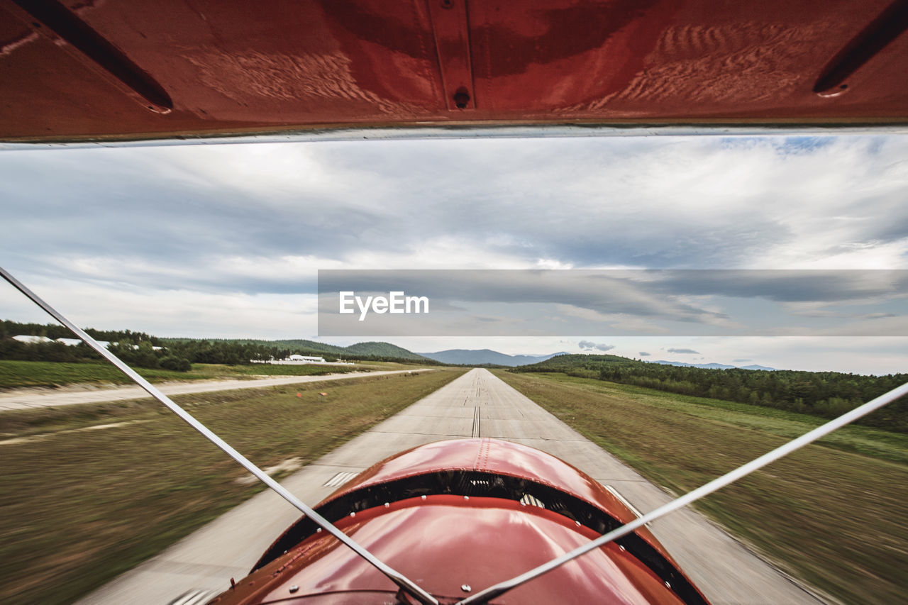 View from cockpit of vintage plane as it lands on runway in maine