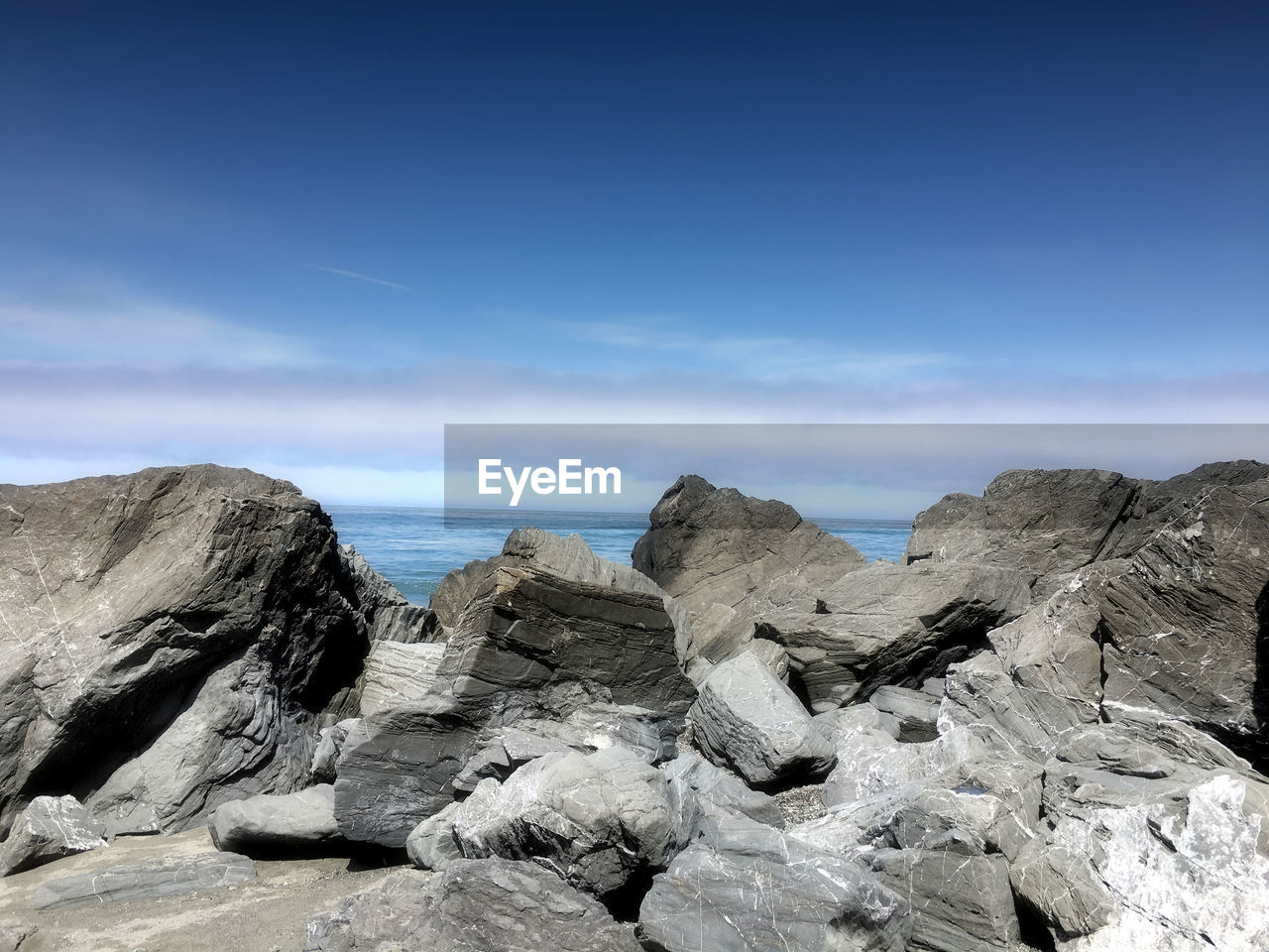 Rocks on beach against sky