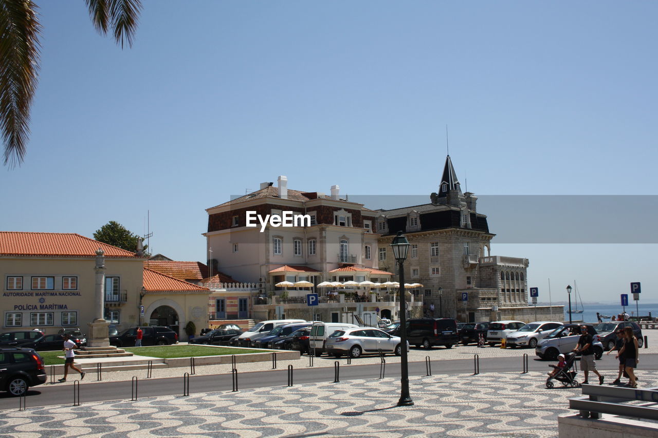 Buildings in town against clear sky