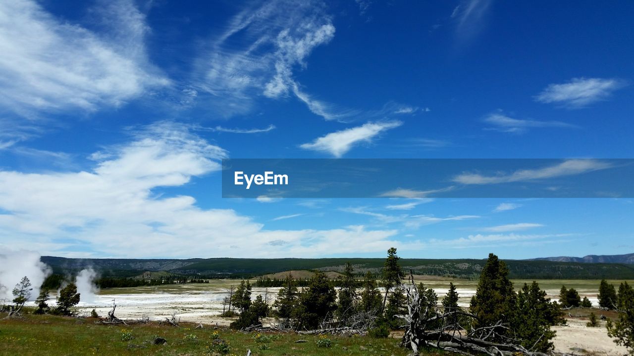 Scenic view of landscape against blue sky