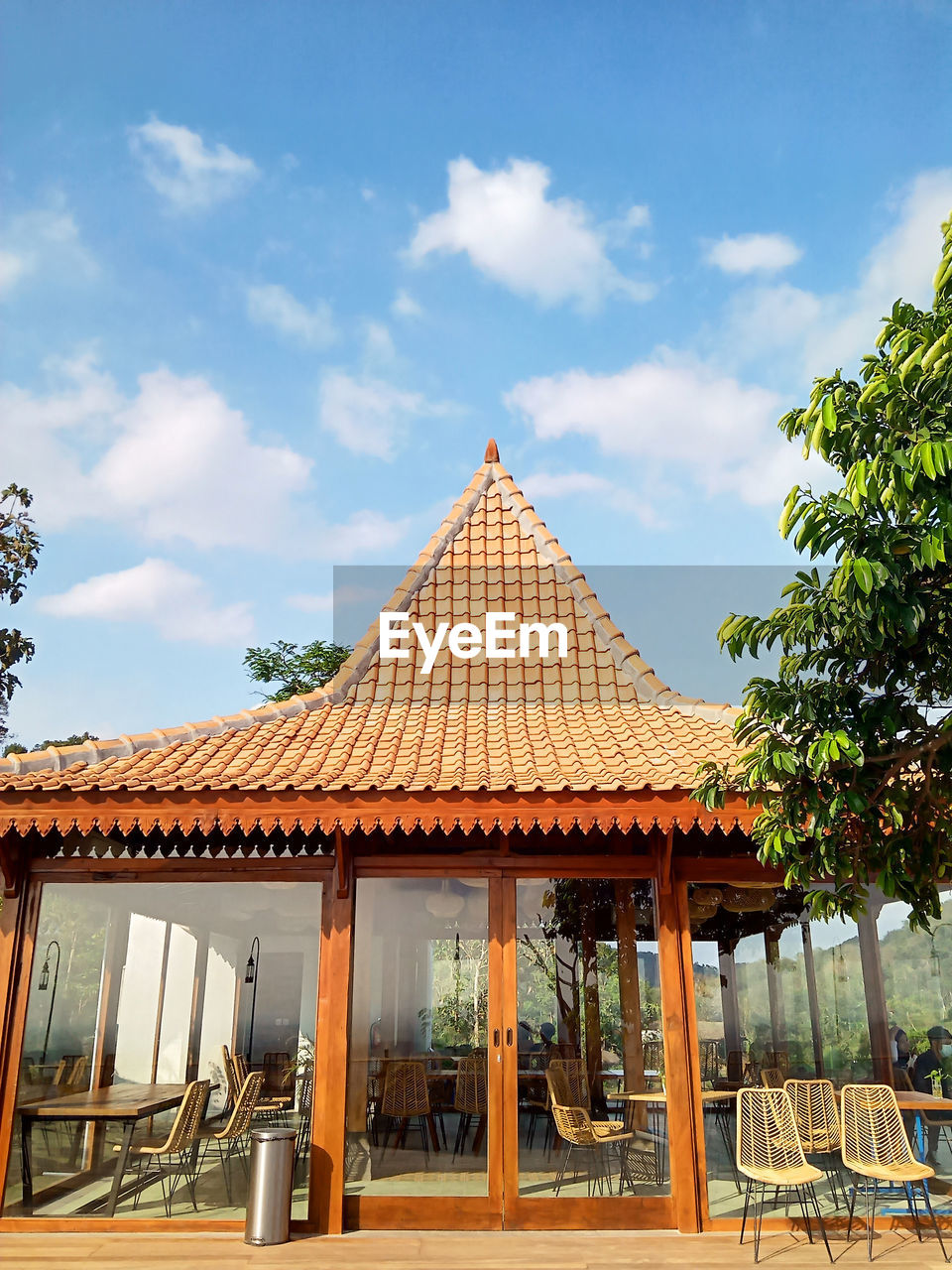 Yogyakarta indonesia 31 may 2021, a cafe building full of glass and wooden chairs at the obelix hill