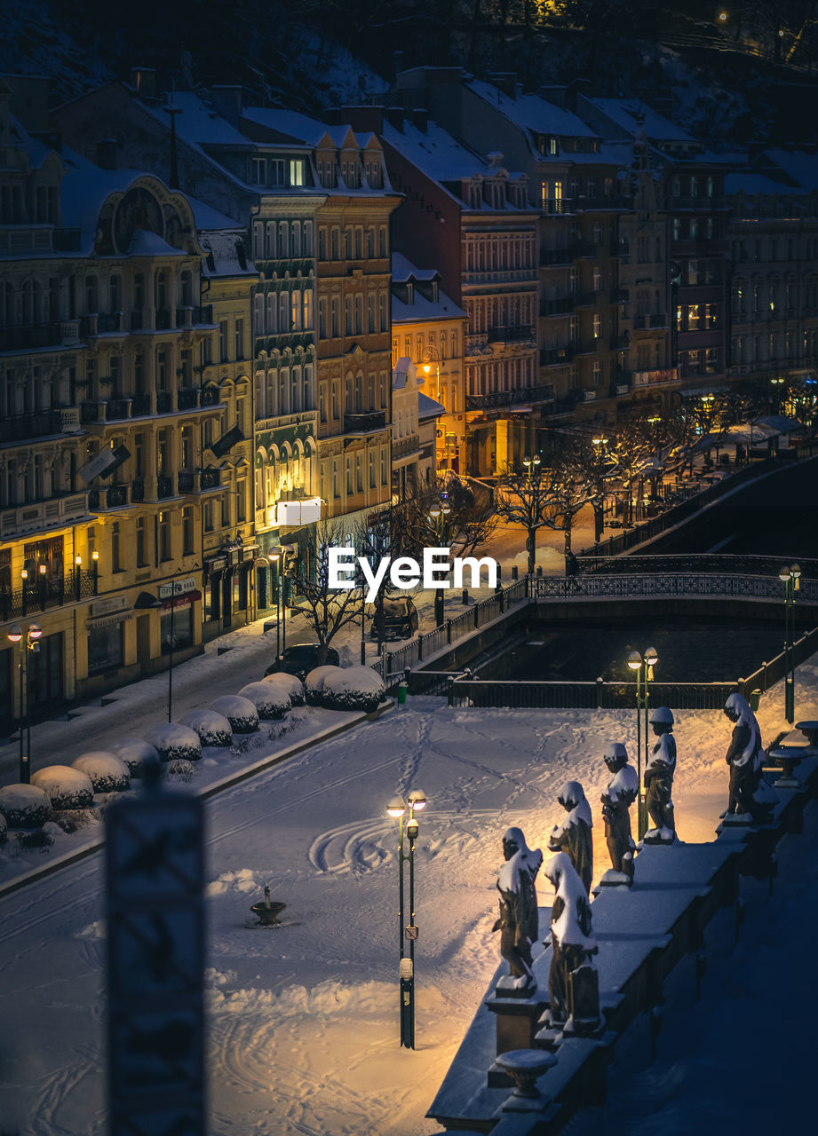 High angle view of illuminated buildings in city at night