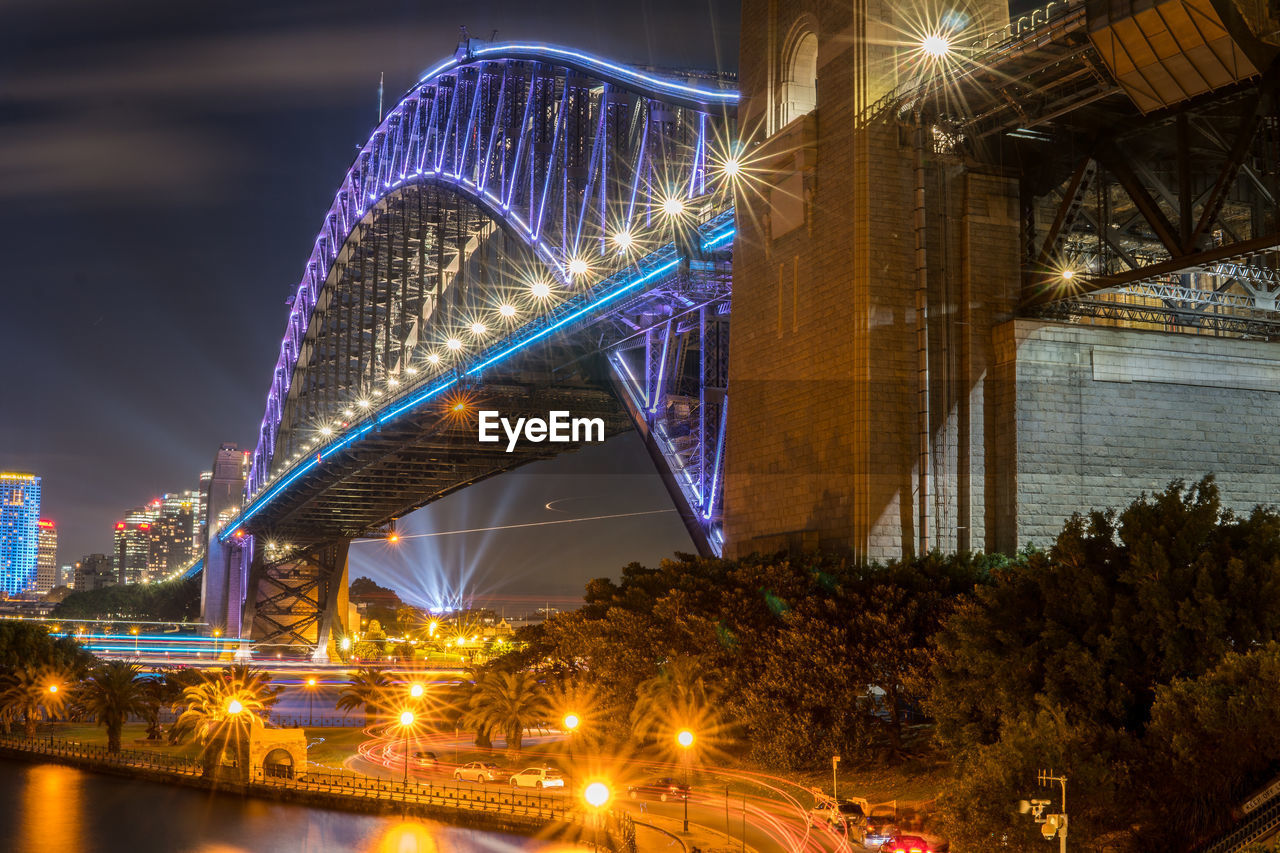 Low angle view of bridge over river at night