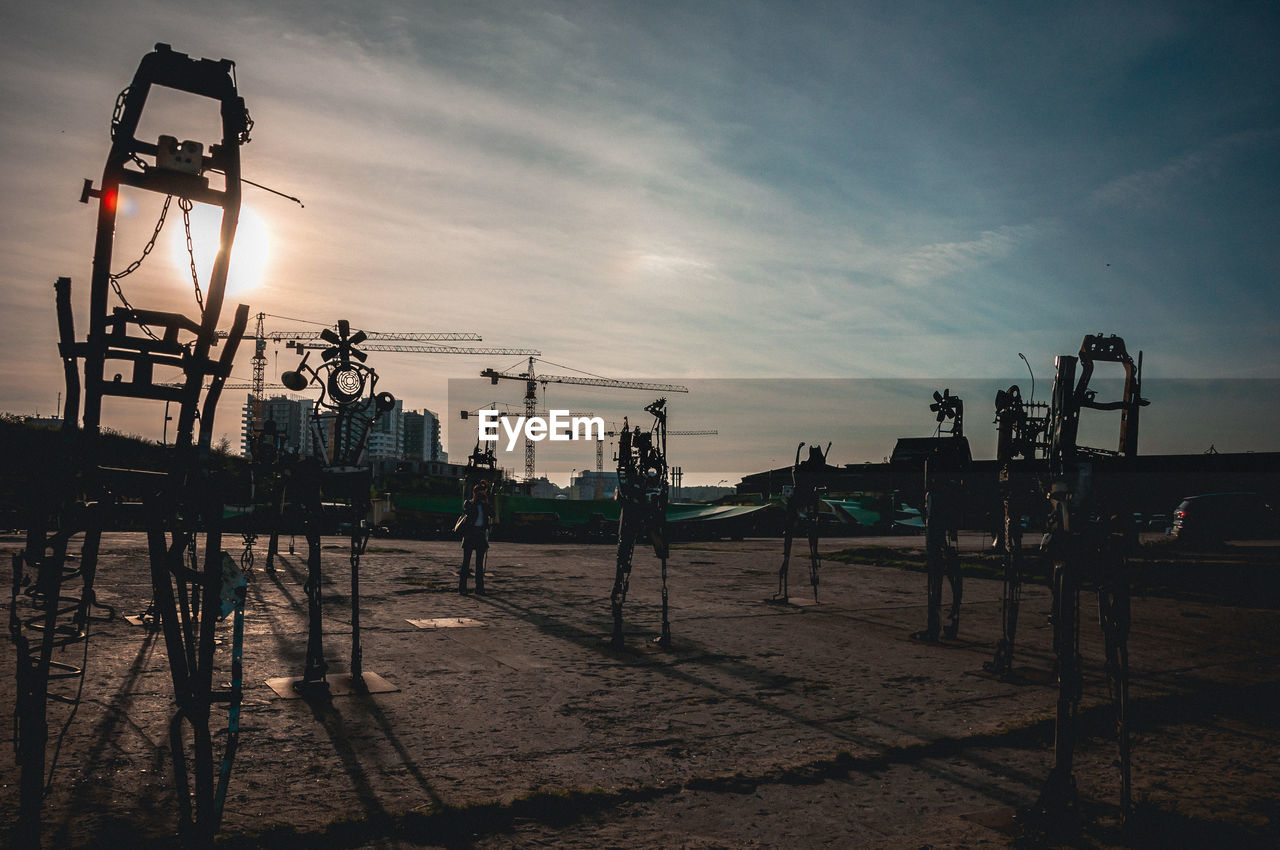 PIER ON BEACH AGAINST SKY DURING SUNSET