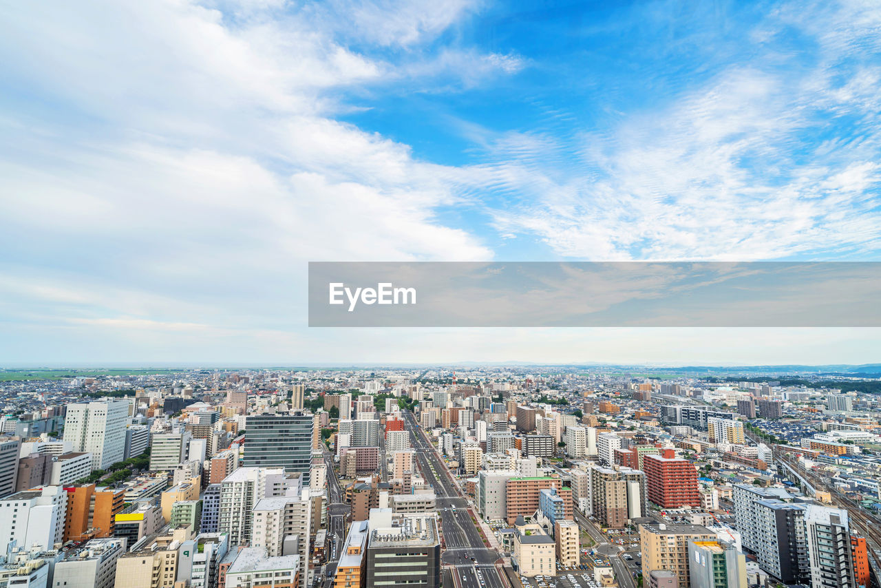 HIGH ANGLE VIEW OF BUILDINGS AGAINST SKY