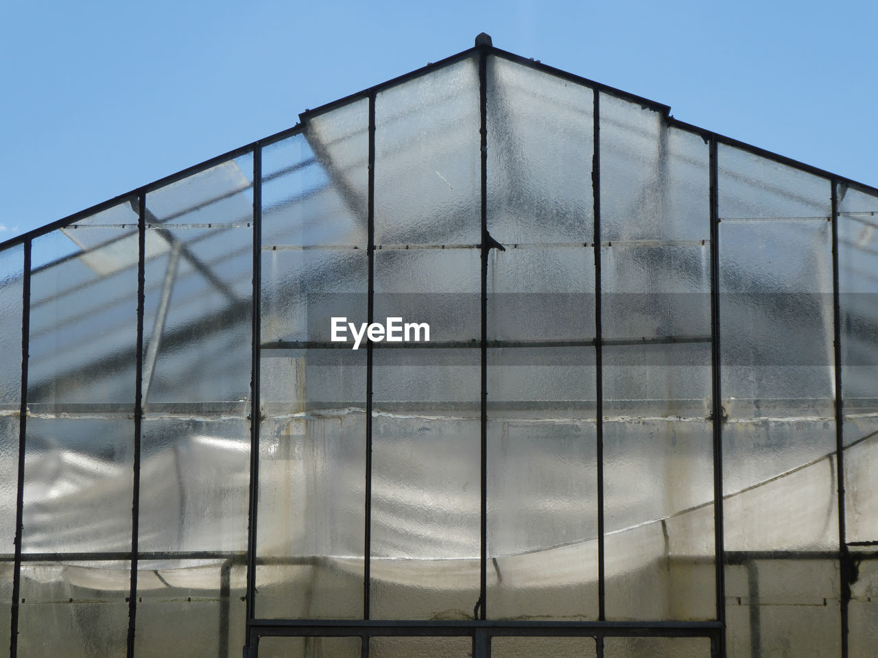 Greenhouse against blue sky