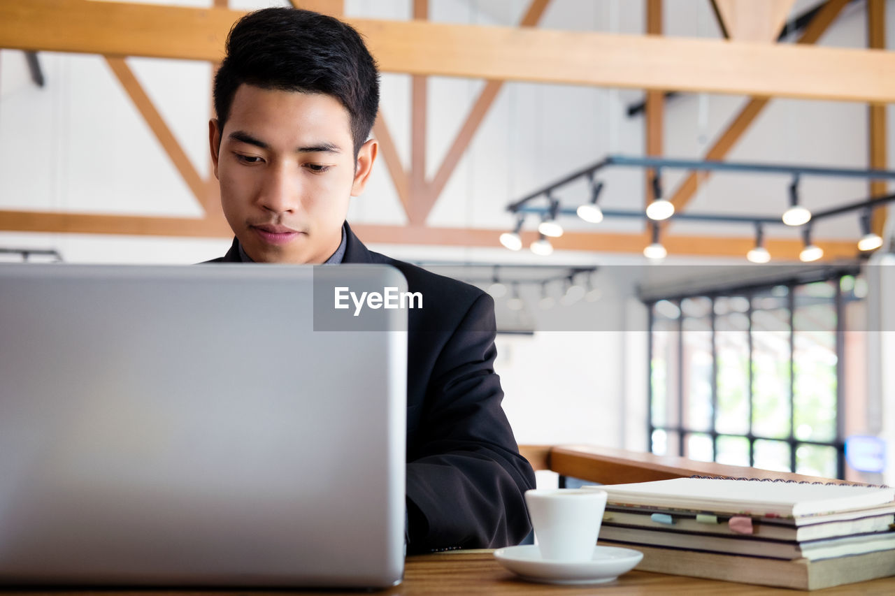 Young businessman working with laptop.