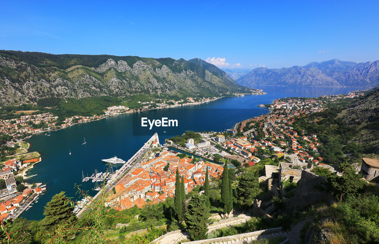 HIGH ANGLE VIEW OF HOUSES AND MOUNTAINS