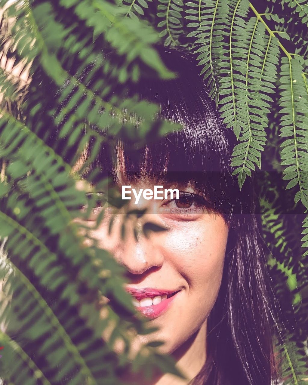 PORTRAIT OF WOMAN WITH PLANTS