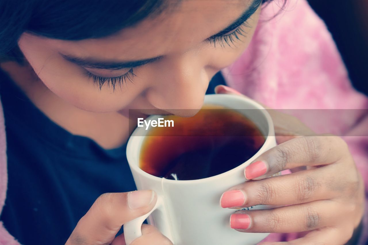 High angle view of woman drinking tea