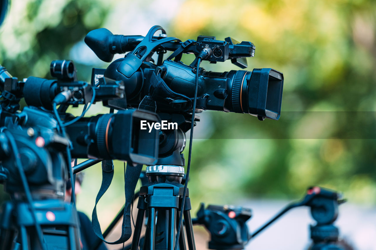 Cameras at a media conference outdoors.