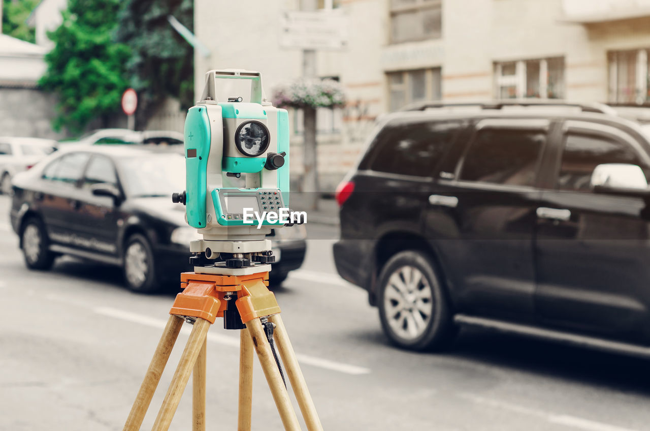 Surveyor device electronic total station on the street. measurement of the relief.