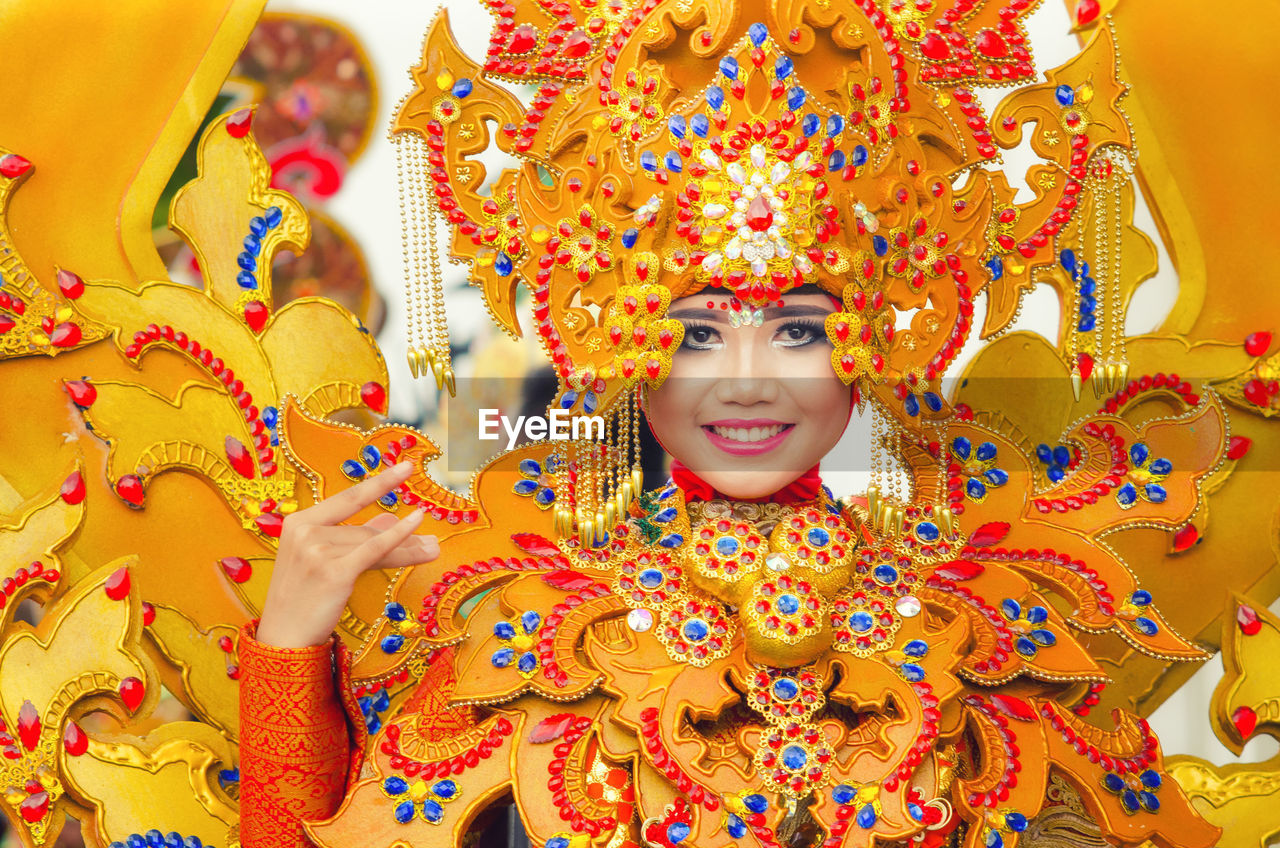 Portrait of smiling young woman in traditional clothing during carnival