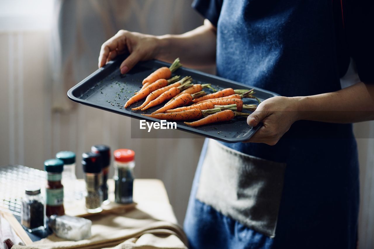 Midsection of man preparing food