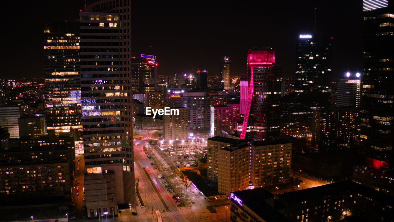 High angle view of illuminated buildings in city at night