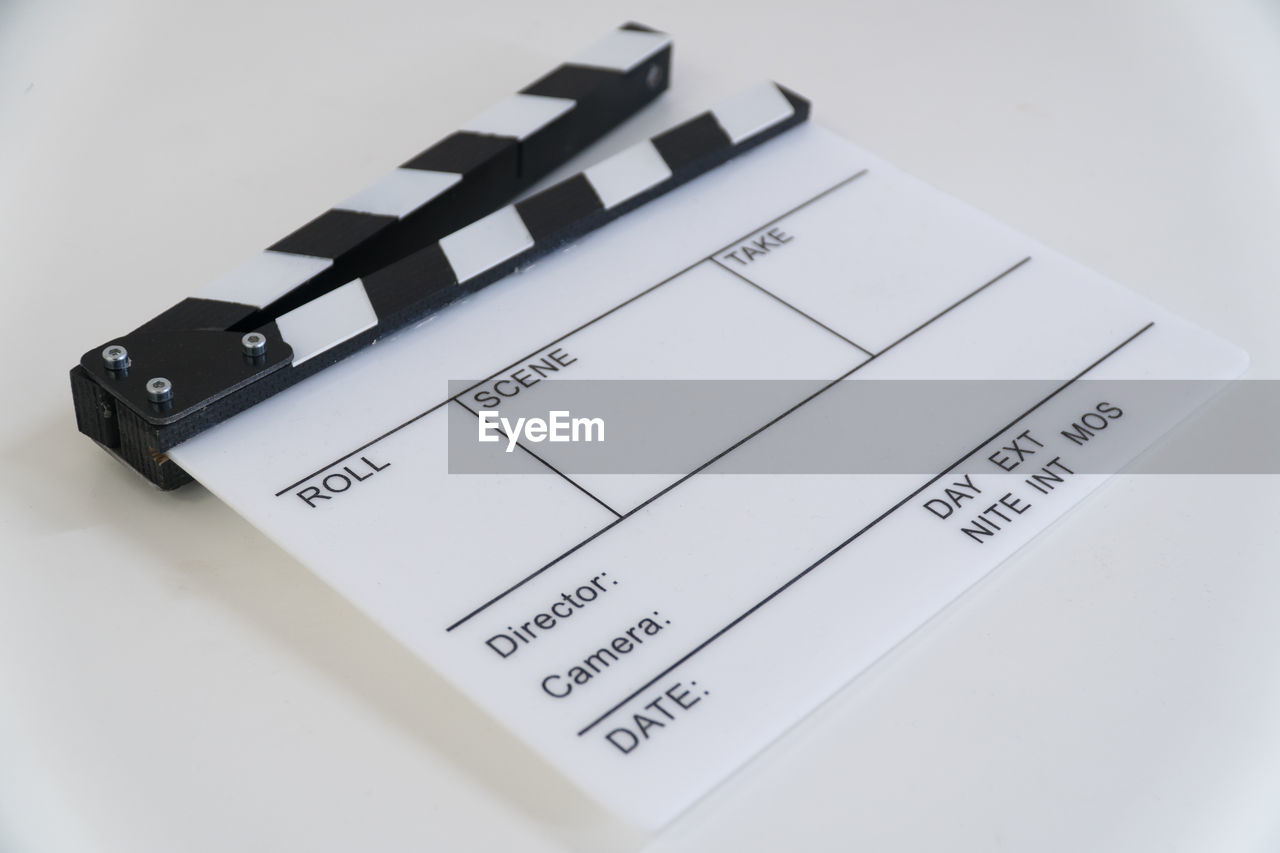 Close-up of clapperboard on white background