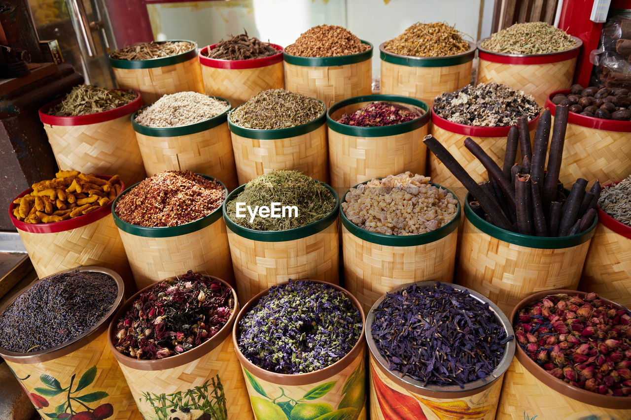 Colorful containers of dried spices, tea and incense at bazaar market in dubai