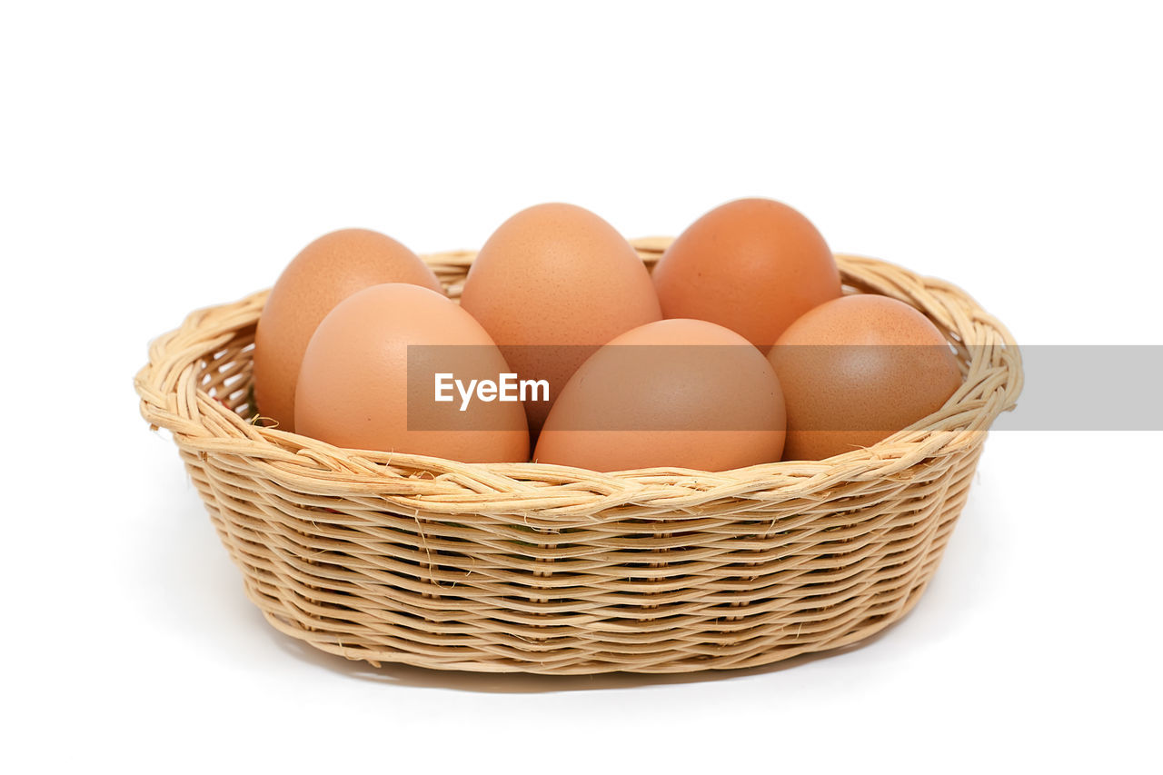 CLOSE-UP OF EGGS AGAINST WHITE BACKGROUND