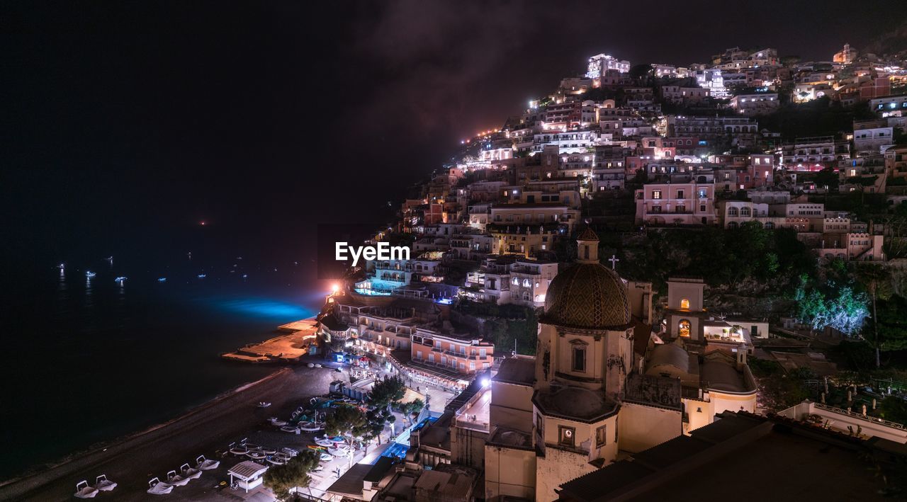 High angle view of illuminated buildings in city at night