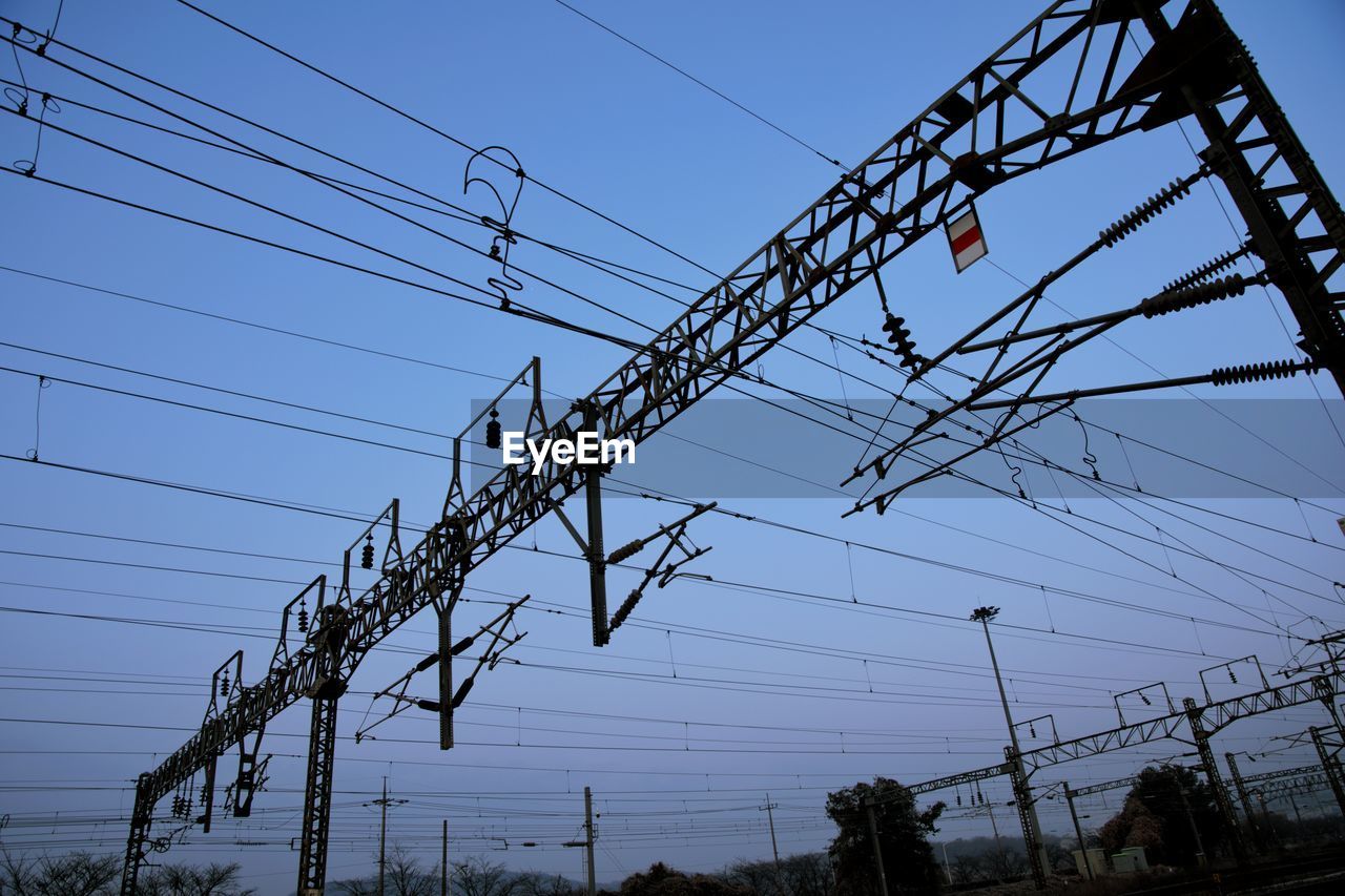 Low angle view of electricity pylon against sky