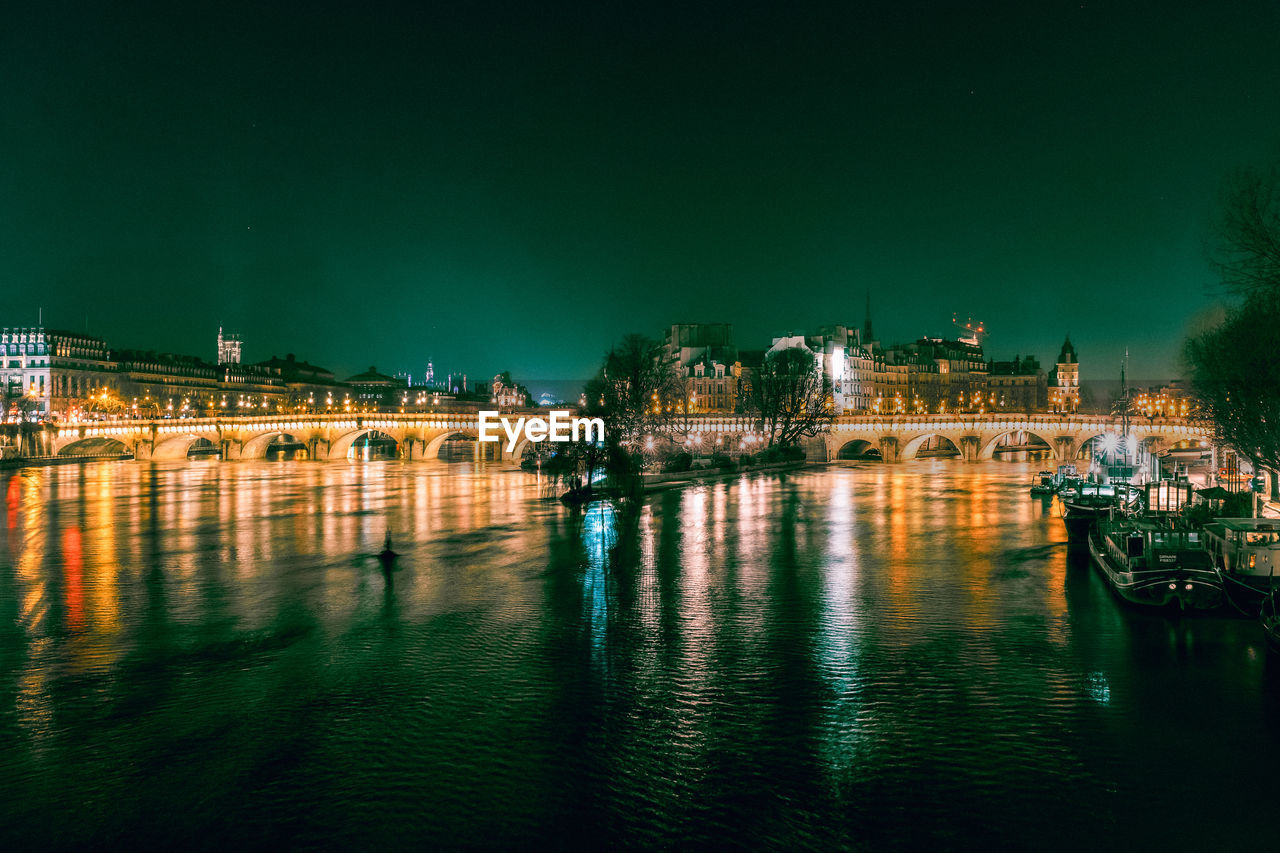 Parisian bridge over seine river at night