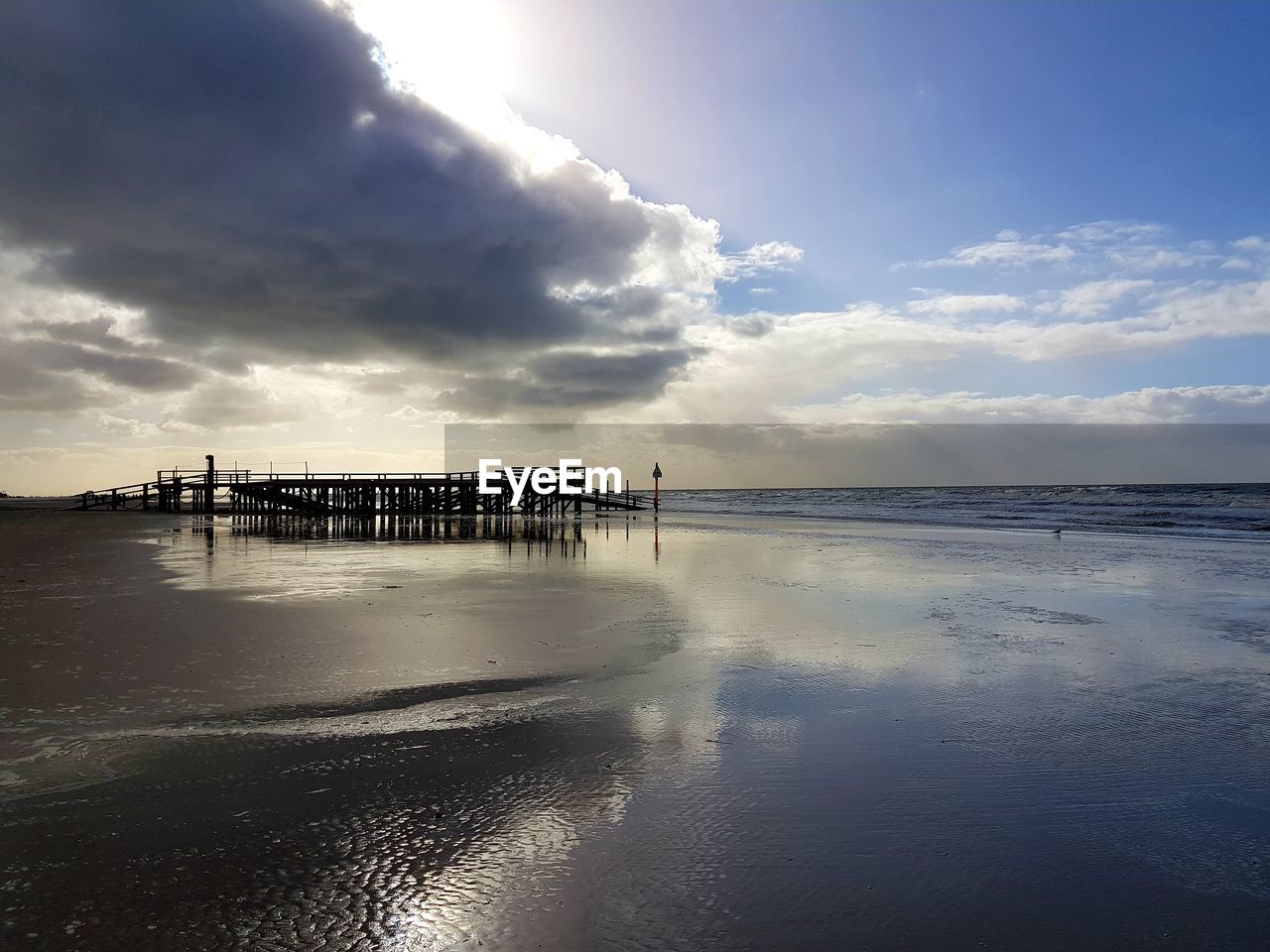 Pier over sea against sky