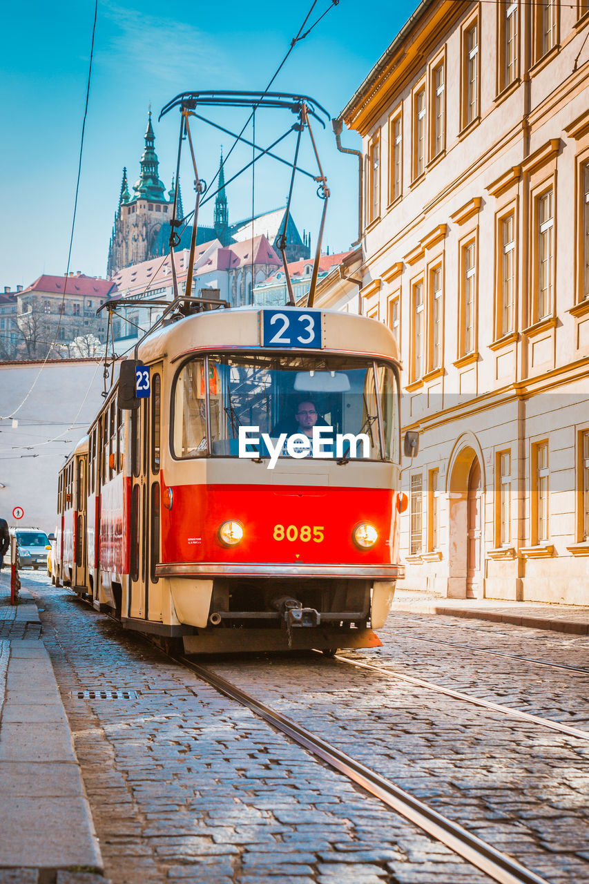 TRAIN ON RAILROAD TRACKS IN CITY