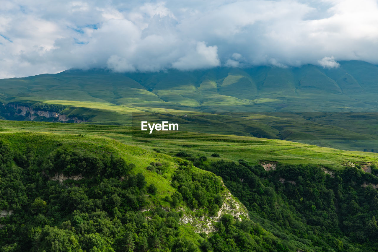 Beautiful green mountains in chechnya. scenic view of landscape against sky