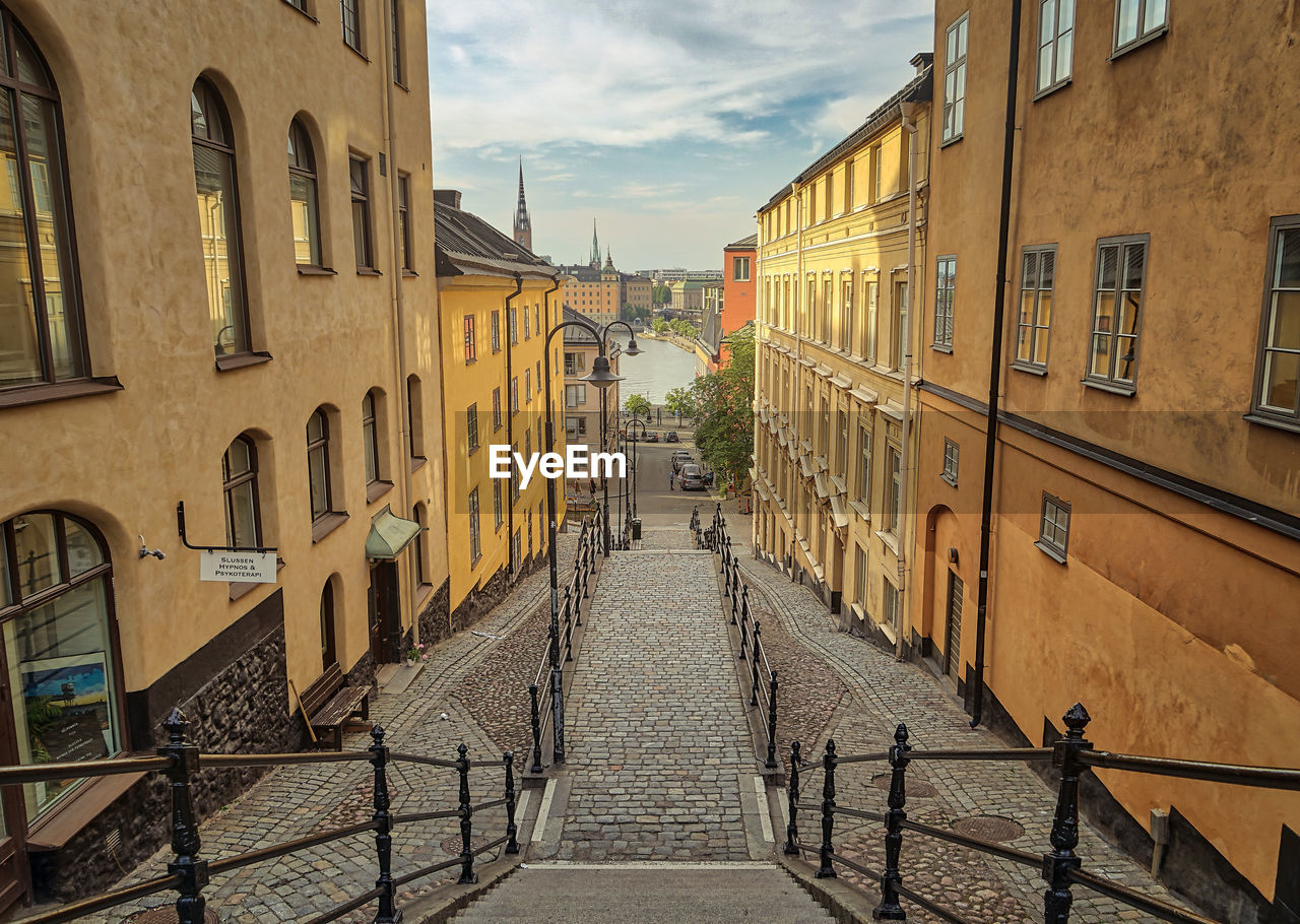 Empty alley amidst buildings in city