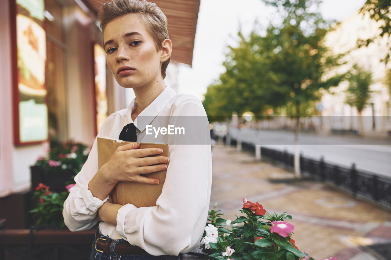 Portrait of young woman woman standing outdoors