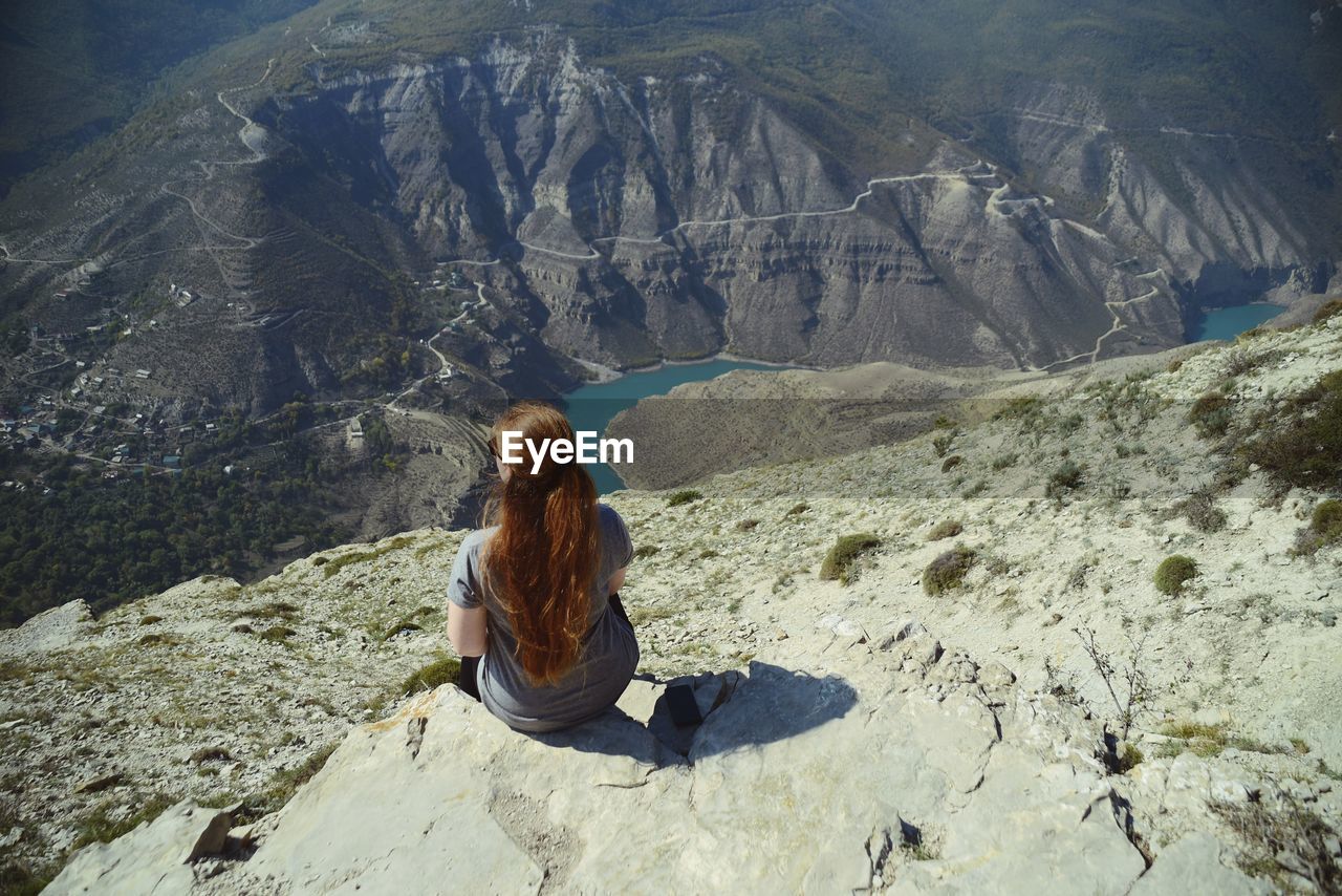 Woman sitting on mountain