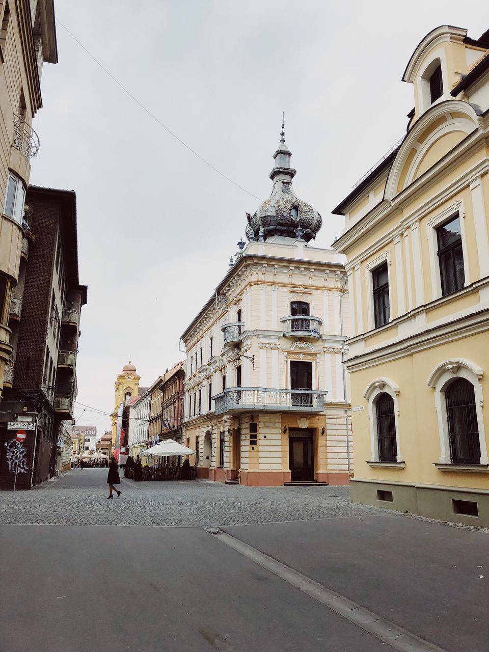 STREET AMIDST BUILDINGS AGAINST SKY