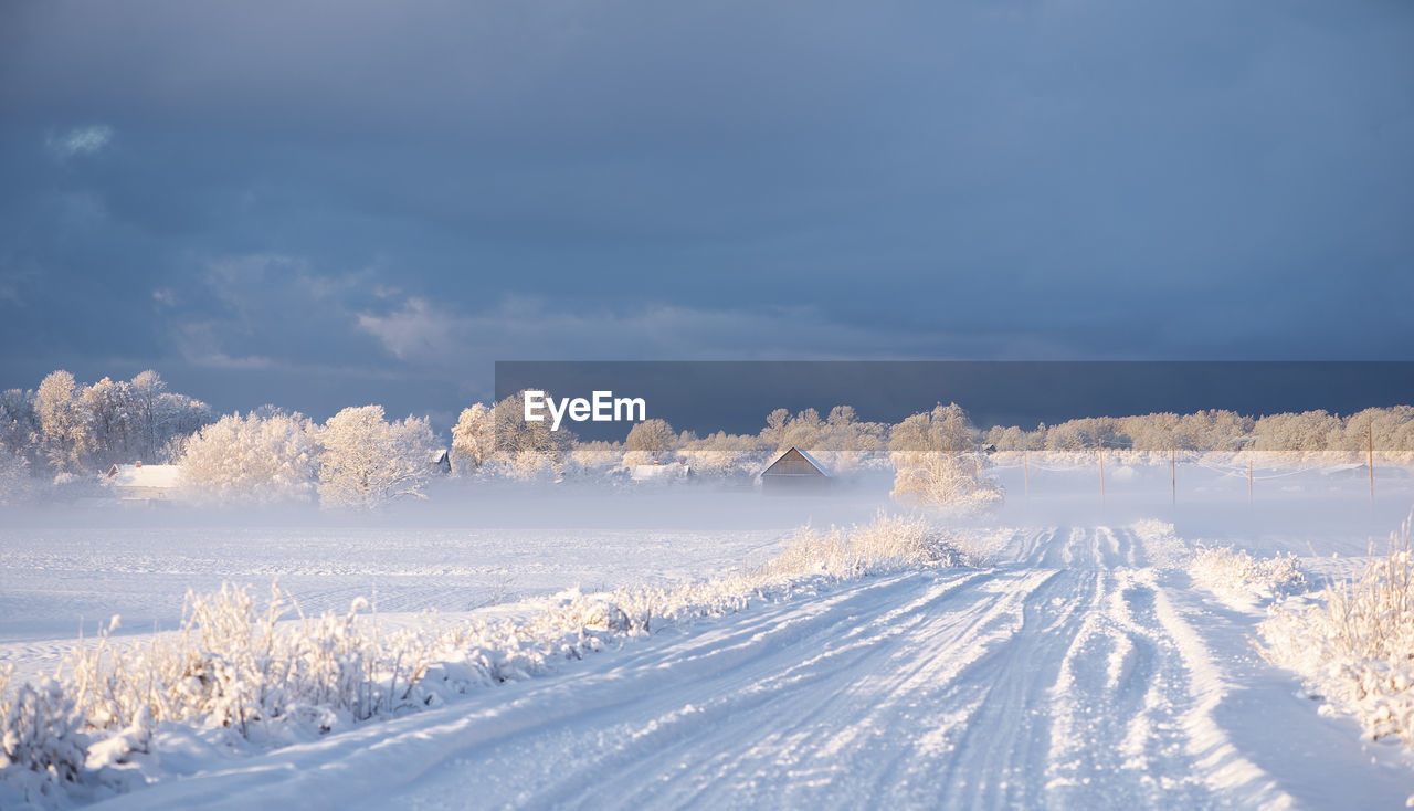 Snow covered land against sky