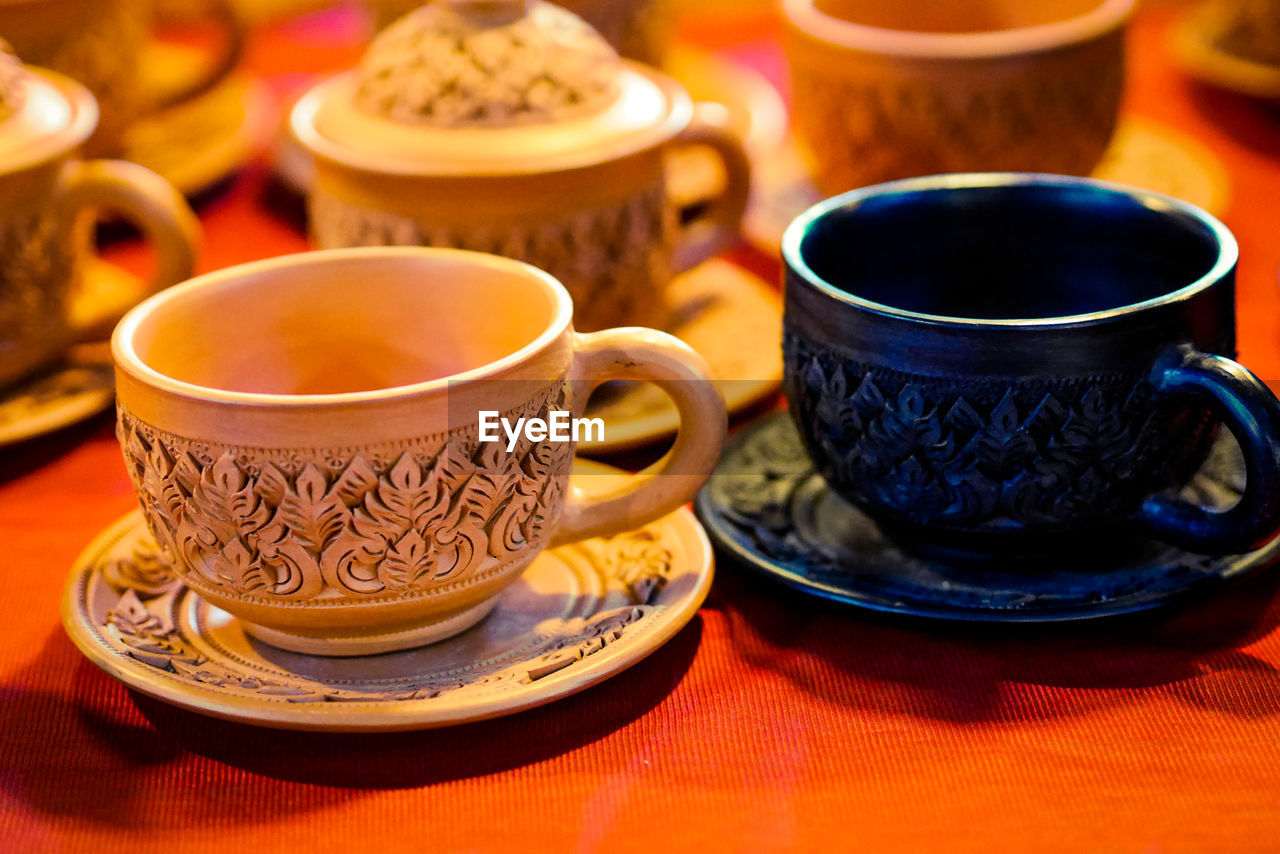 CLOSE-UP OF TEA CUP AND COFFEE ON TABLE