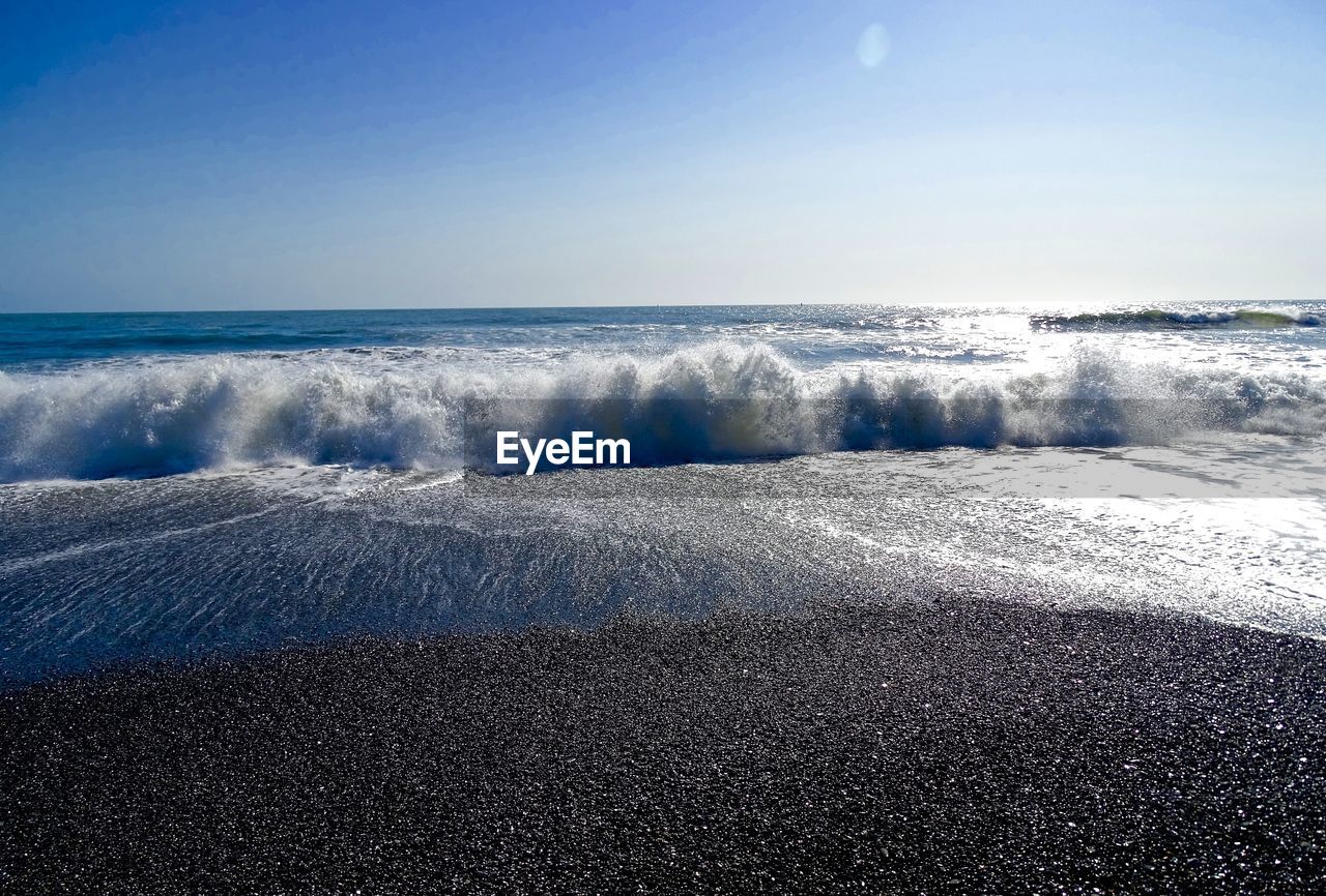 Scenic view of sea against clear blue sky